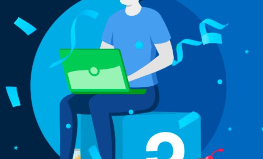 Kreslený muž s narozeninovou čepicí sedí na kostce s logem a pracuje na notebooku.